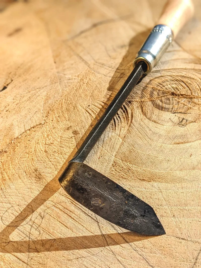 Cape Cod Weeder, right or left handed by Homestead Iron on wooden background with kids drawing.