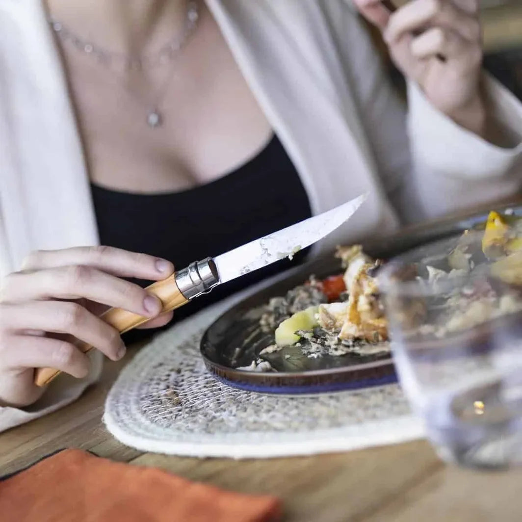 Opinel 8 fillet folding knife on Homestead Iron site. Woman eating.