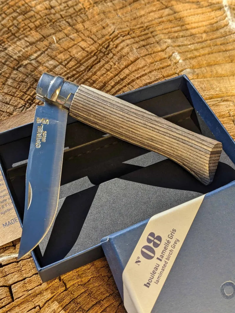 Opinel #8 Gray stainless steel folding knife on Homestead Iron site with wooden background