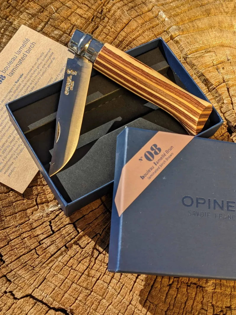 Opinel #8 Stainless steel folding pocket knife on wooden background from Homestead Iron Site.