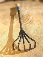 Crow's Foot Garden Tool, Hand Forged "The Claw". Image of full tool on Wooden background. 