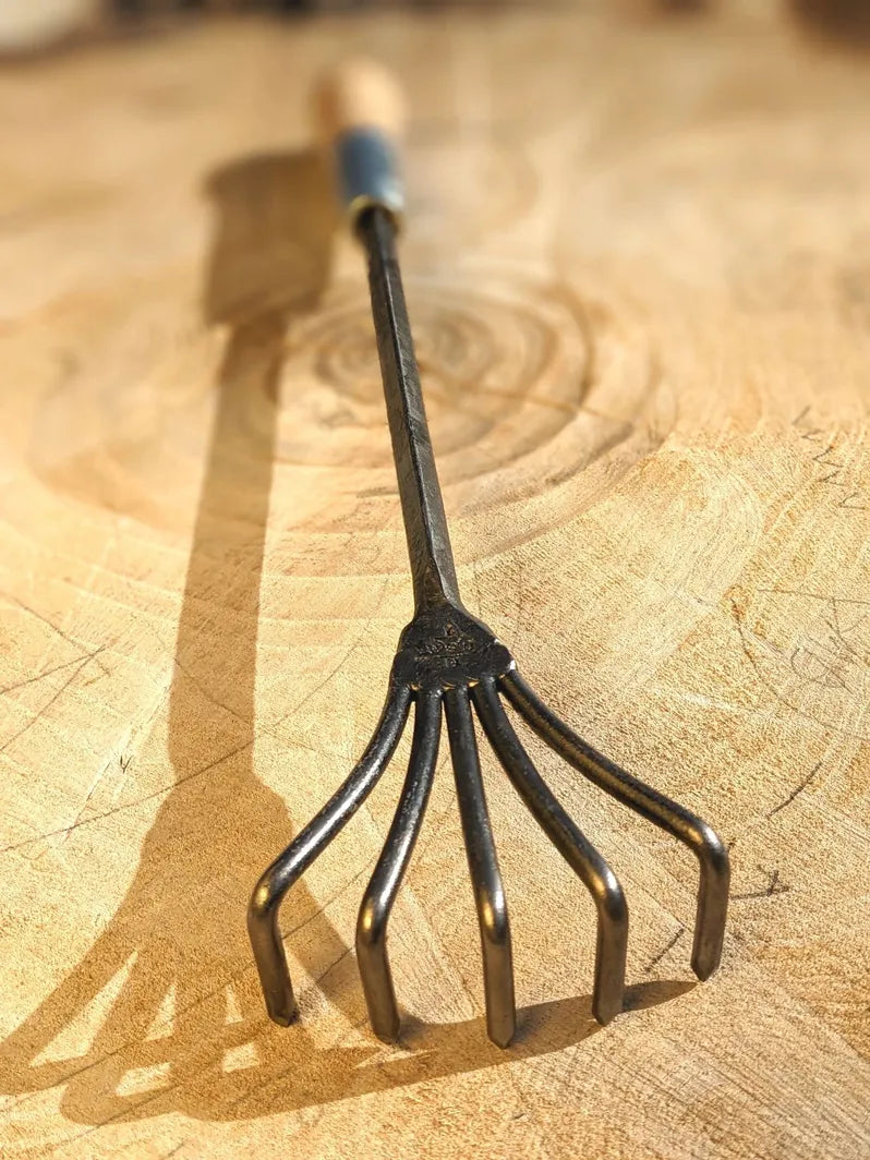 Crow's Foot Garden Tool, Hand Forged "The Claw". Image of full tool on Wooden background. 