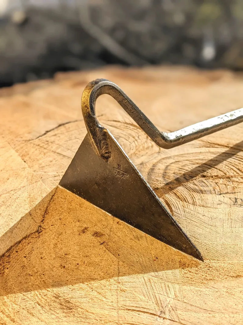 Dutch Weeder, Right or Left Handed by Homestead Iron with sharp shadows on wood.