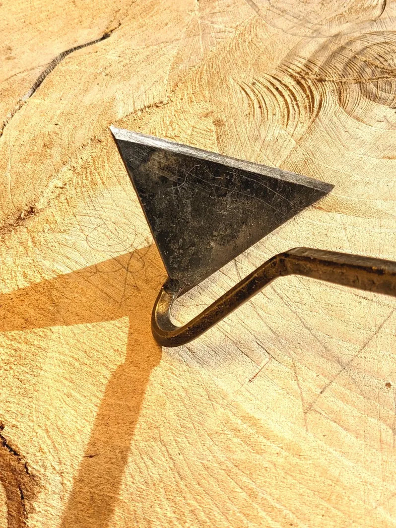 Dutch Weeder, Right or Left Handed by Homestead Iron highlighting head with kids drawing on wood in background.