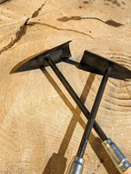 Hawk's Bill Weeder by Homestead Iron  on wooden background with deep shadows.