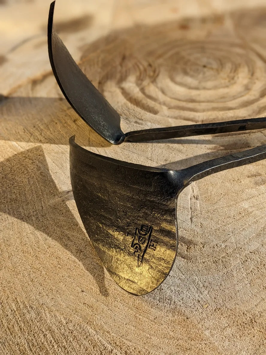 Ho Mi Hand Plow, right or left handed Homestead Iron focus on tool head with gold light