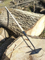 Scuffle Weeder, Hand Forged Garden Tool, Long Handle on tree log.