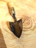 Small Trowel, Hand Forged Garden Tool Homestead Iron close up tool head on wooden background