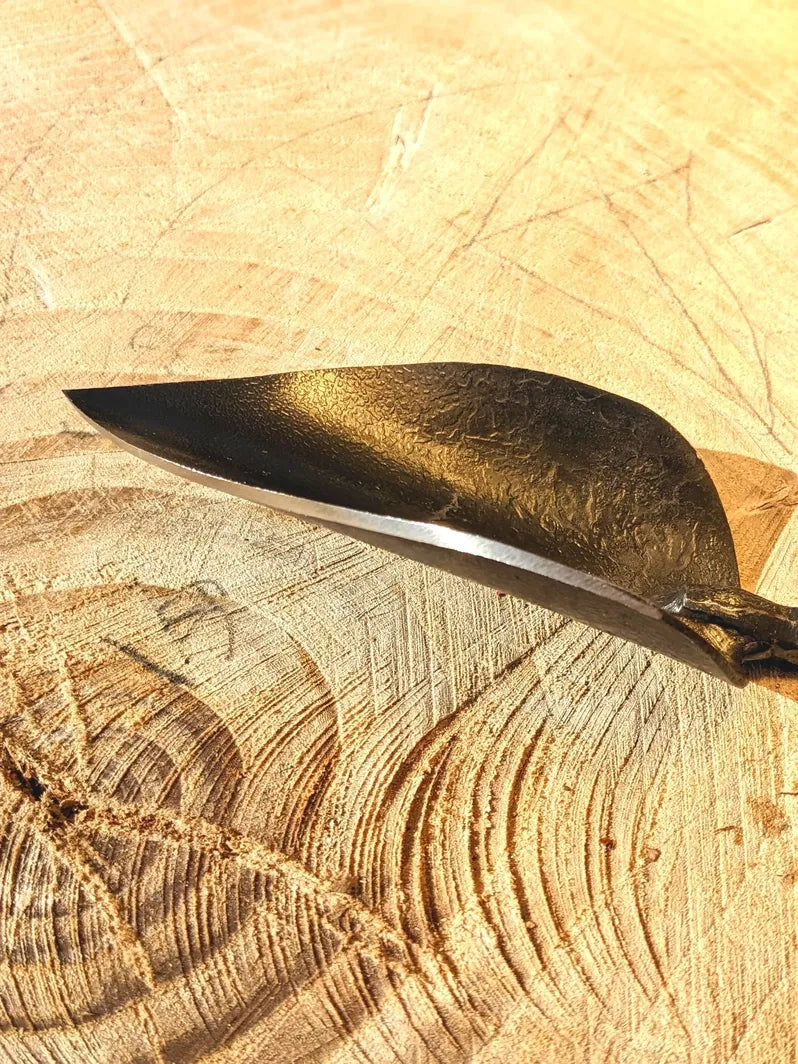 Small Trowel, Hand Forged Garden Tool Homestead Iron close up tool head on wooden background
