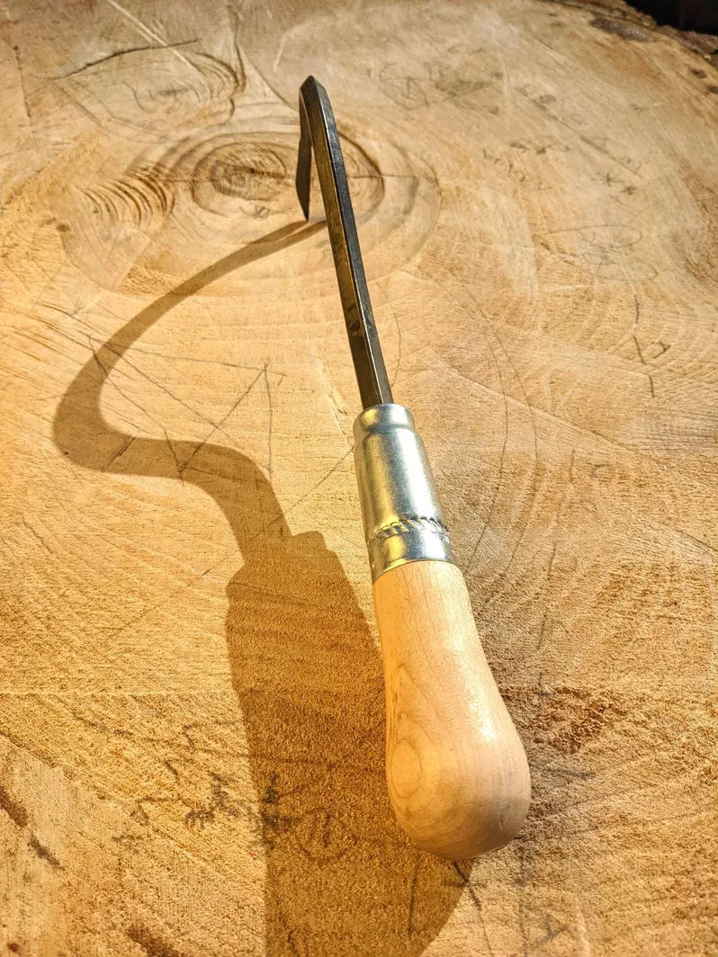 Weed Yanker, Hand Forged Garden Tool focus on handle on wooden background. 