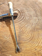 Weeding fork by Homestead Iron on wooden background. 